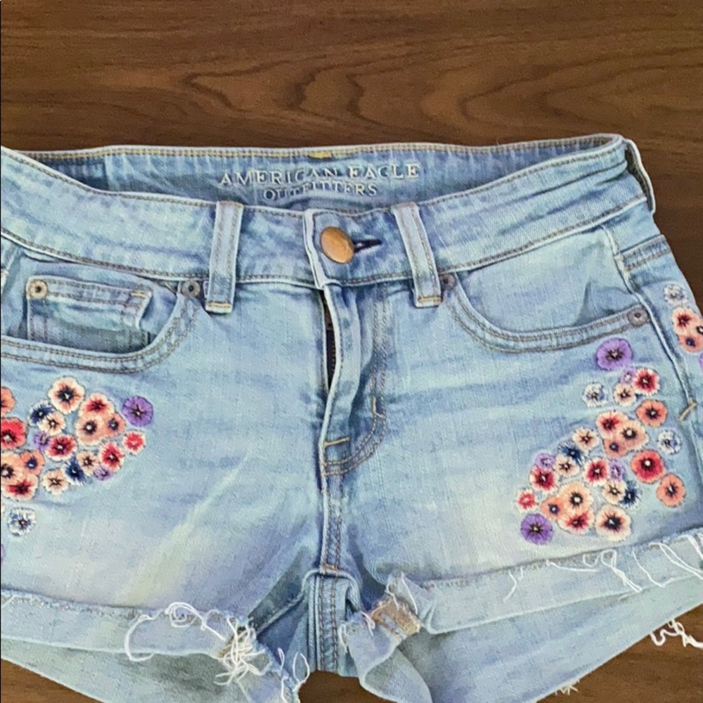American Eagle “Shortie” denim shorts w/ flowers